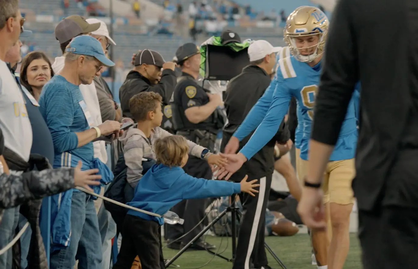 Football player high-fiving fans